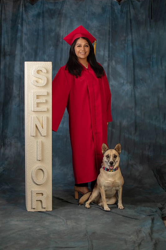 senior portrait young lady cap gown dog