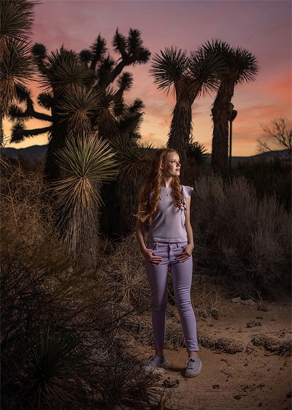 Evoto young lady in lavender clothing at sunset in desert
